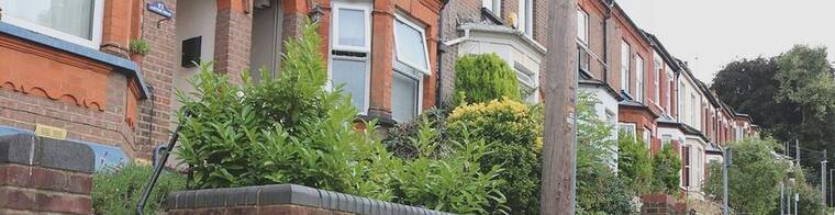 A street of red-brick terraced houses in Luton